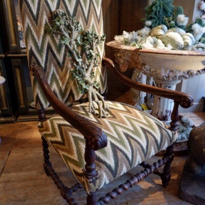 Pair of large carved oak armchairs with scrolls and flamed fabric, Louis XIV period
