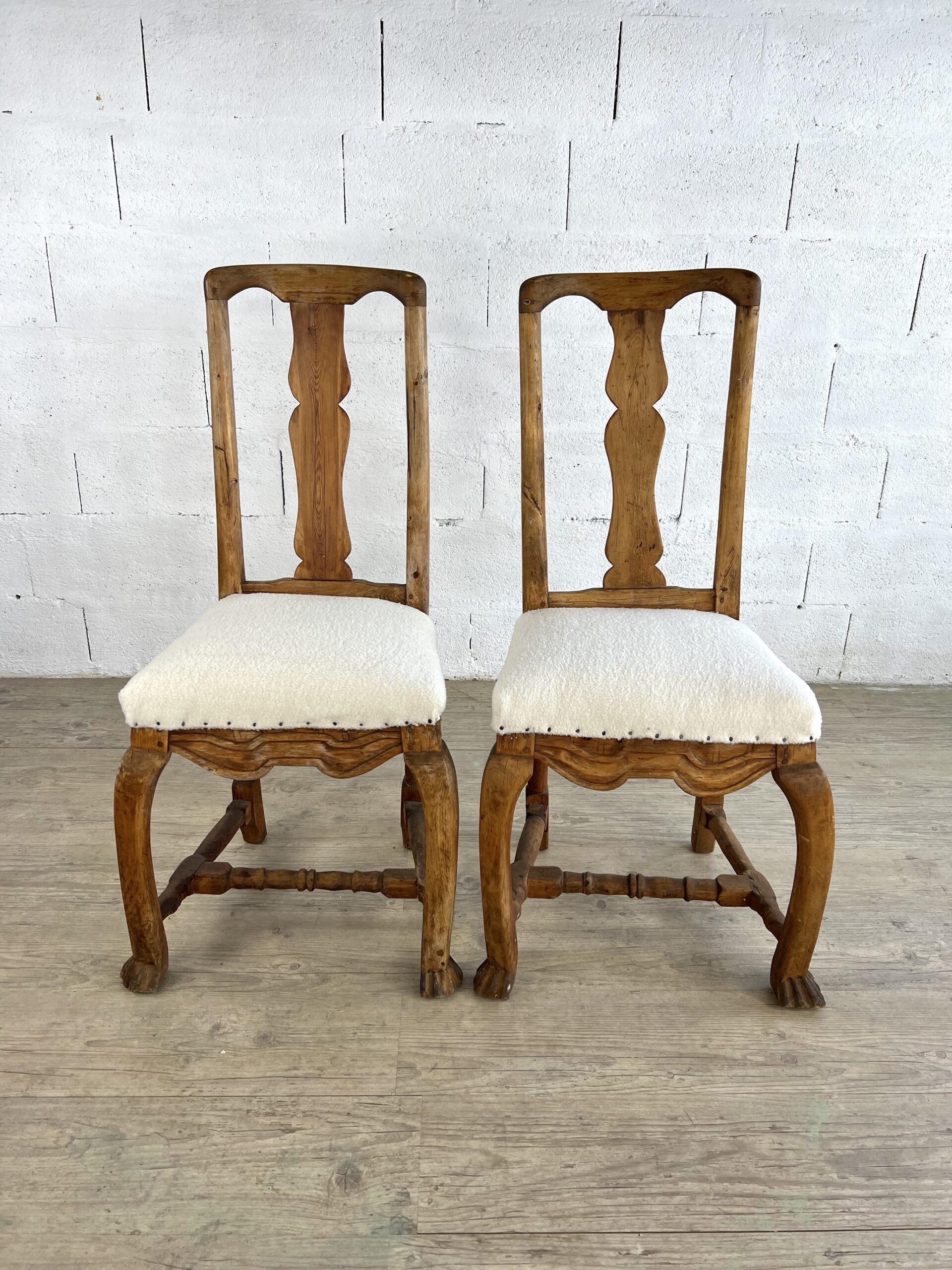 Pair of chairs in rough carved wood